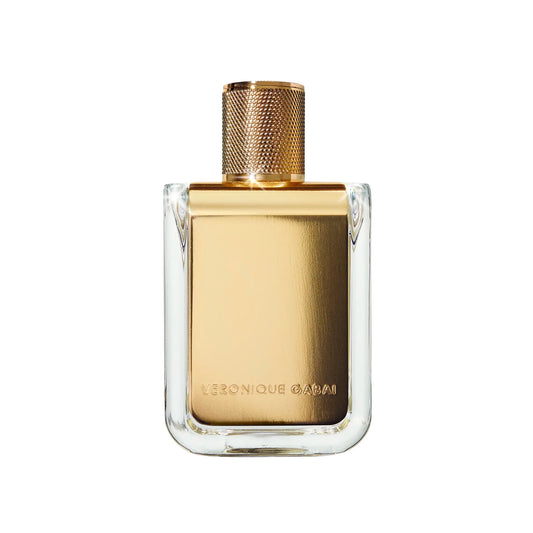 Square glass perfume bottle with gold metal label printed with 'Veronique Gabai' and a gold cap on a white background.