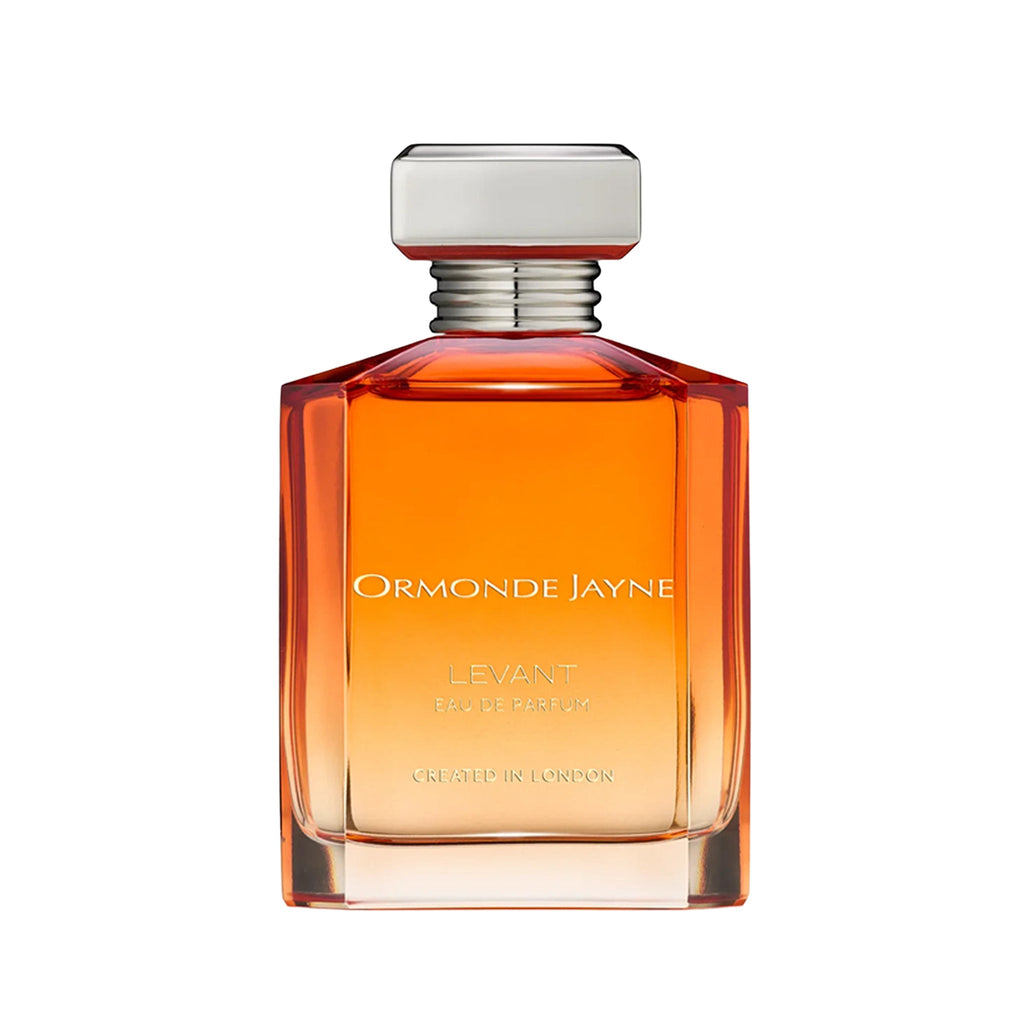 Rectangular, faceted orange glass bottle with siilver cap, labeled with 'Levant' by Ormonde Jayne