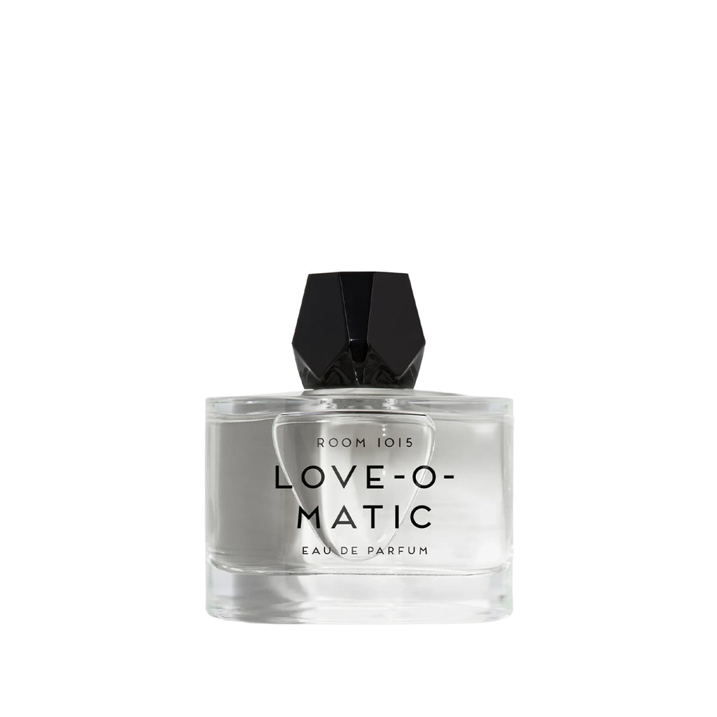 Perfume bottle with faceted black cap labeled 'LOVE-O-MATIC' on a white background