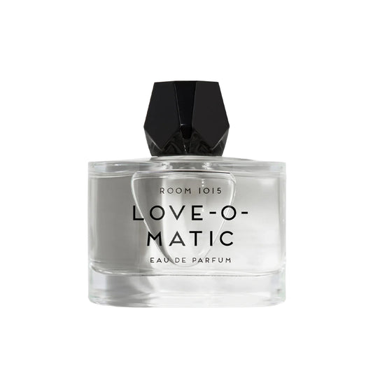 Perfume bottle with faceted black cap labeled 'LOVE-O-MATIC' on a white background