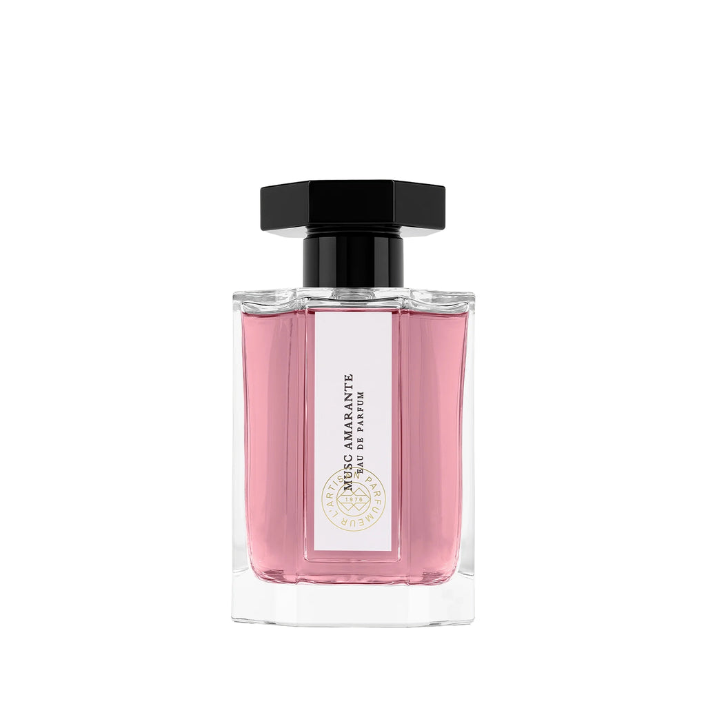 Pink perfume bottle with a white label, pink liquid and black cap on a white background